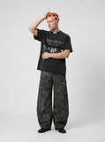 DAXUEN Black short-sleeved t-shirt with distressed text and graphics — model photo