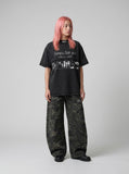 DAXUEN Black short-sleeved t-shirt with distressed text and graphics — model photo