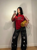 DAXUEN black distressed wide-leg denim pants with star motifs — model photo