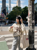 DAXUEN cream denim shirt with distressed brown graphic — model photo