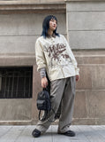 DAXUEN cream denim shirt with distressed brown graphic — model photo