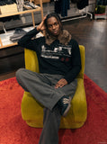 DAXUEN black long-sleeved polo with distressed cityscape graphic — model photo