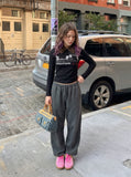 DAXUEN black long-sleeved polo with distressed cityscape graphic — model photo