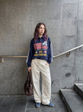 DAXUEN navy blue long-sleeve polo with distressed collegiate graphic — model photo