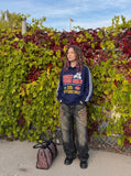 DAXUEN navy blue long-sleeve polo with distressed collegiate graphic — model photo