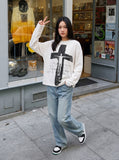 DAXUEN white oversized distressed-cross graphic long-sleeve top — model photo