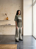 DAXUEN dark olive oversized silhouetted crowd graphic t-shirt — model photo