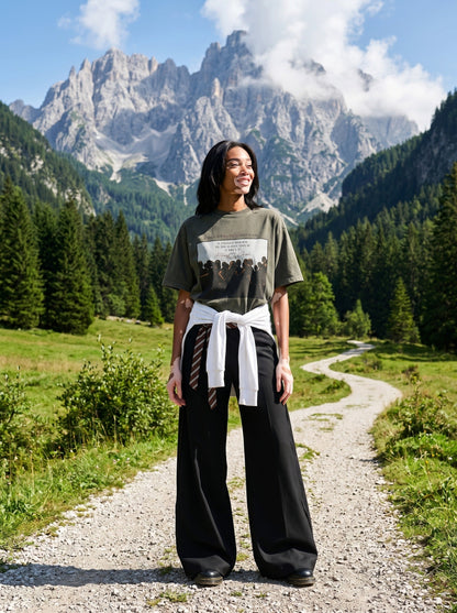 DAXUEN dark olive oversized silhouetted crowd graphic t-shirt — model photo