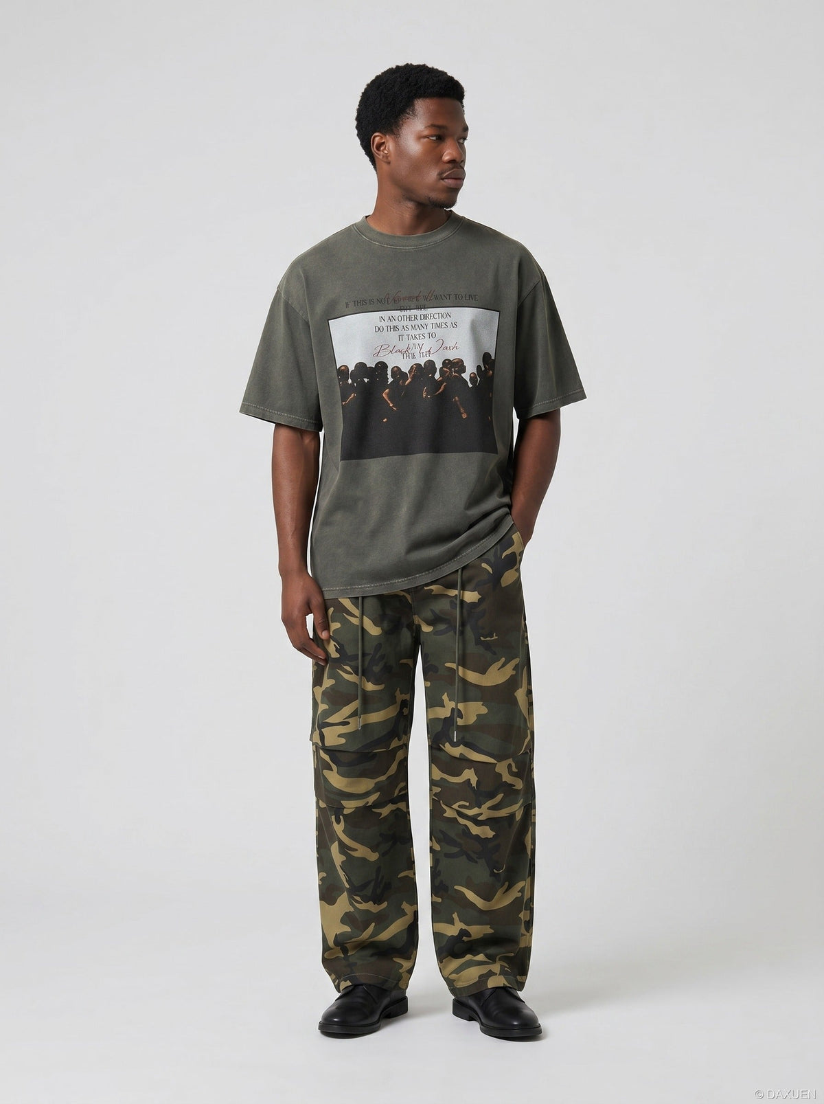 DAXUEN dark olive oversized silhouetted crowd graphic t-shirt — model photo