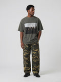 DAXUEN dark olive oversized silhouetted crowd graphic t-shirt — model photo