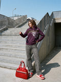 DAXUEN dark purple distressed floral graphic long-sleeve top — model photo