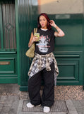 DAXUEN black oversized distressed face graphic tank — model photo
