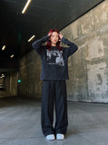 DAXUEN black distressed figures graphic long sleeve t-shirt — model photo