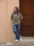 DAXUEN olive green oversized distressed five-figure graphic t-shirt — model photo