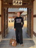DAXUEN black knit top with distressed flag graphic — model photo