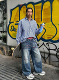 DAXUEN Men's wide-leg denim jeans with floral embroidery — model photo