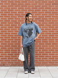 DAXUEN washed blue oversized distressed face graphic t-shirt — model photo