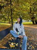 DAXUEN Distressed graphic long sleeve crew neck top — model photo