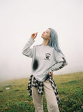 DAXUEN Distressed graphic long sleeve crew neck top — model photo