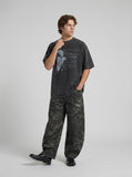 DAXUEN dark grey oversized distressed graphic person tee — model photo