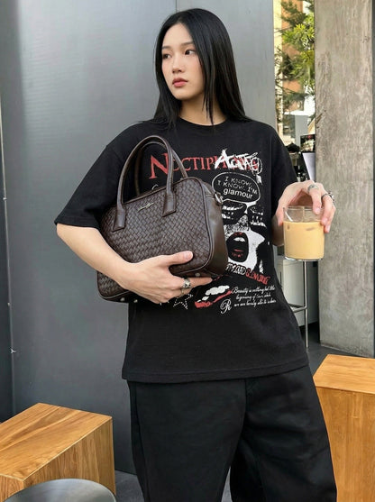 DAXUEN Black short-sleeved t-shirt with distressed graphic design — model photo
