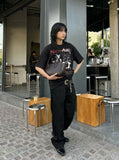 DAXUEN Black short-sleeved t-shirt with distressed graphic design — model photo