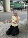 DAXUEN Distressed graphic ruched short-sleeved t-shirt — model photo