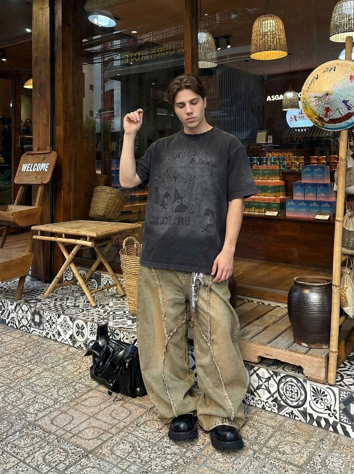 DAXUEN Distressed black graphic t-shirt with raw-edge neckline — model photo