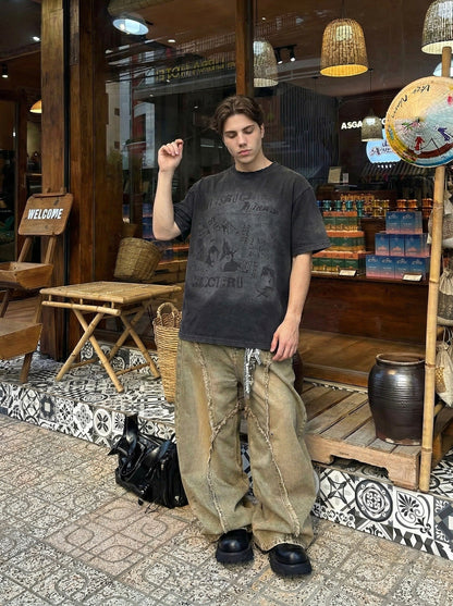 DAXUEN Distressed black graphic t-shirt with raw-edge neckline — model photo