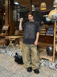 DAXUEN Distressed black graphic t-shirt with raw-edge neckline — model photo