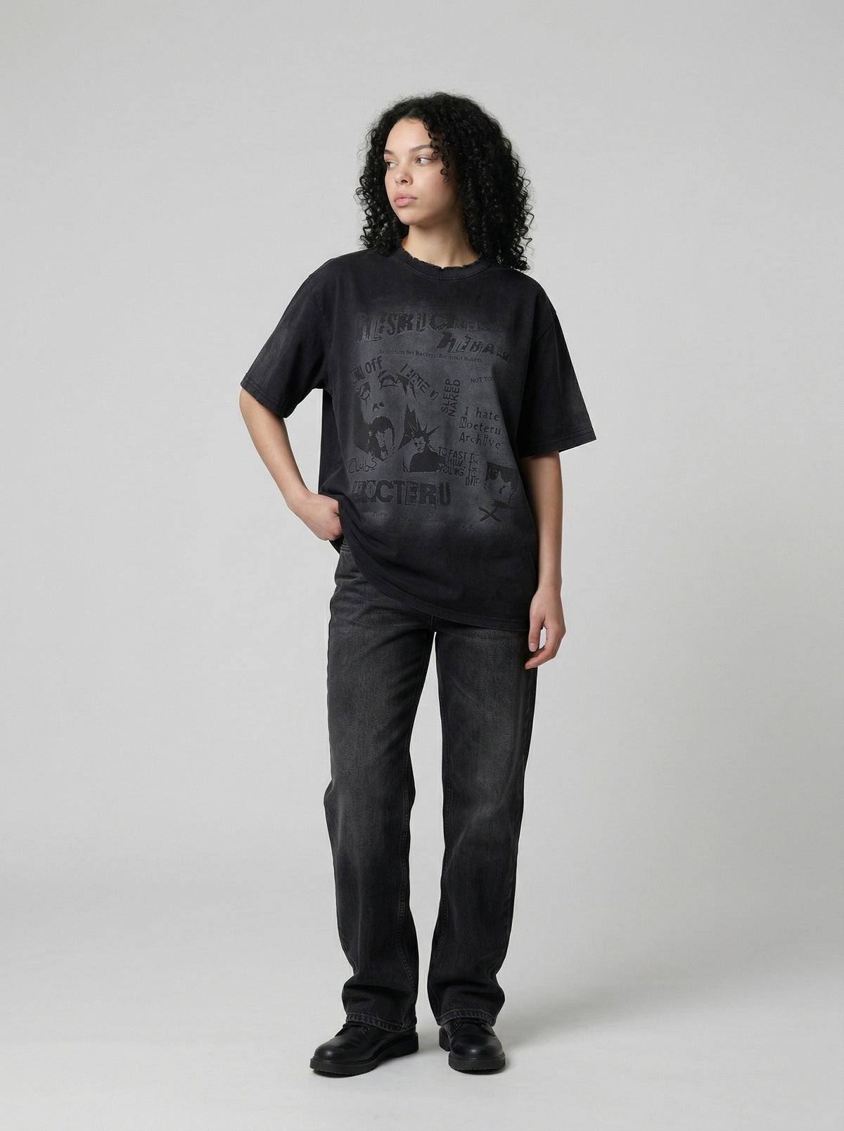 DAXUEN Distressed black graphic t-shirt with raw-edge neckline — model photo