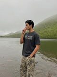 DAXUEN faded black distressed text graphic t-shirt — model photo