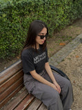DAXUEN faded black distressed text graphic t-shirt — model photo