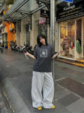 DAXUEN Distressed oversized T-shirt with heart graphic — model photo
