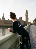 DAXUEN black long sleeve distressed musical-note graphic top — model photo