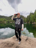 DAXUEN washed dark charcoal grey oversized distressed number graphic hoodie sweatshirt — model photo