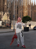 DAXUEN ecru oversized distressed portrait grid tee — model photo