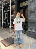 DAXUEN white oversized distressed red graphic tee — model photo