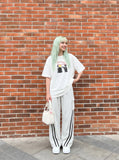 DAXUEN white oversized distressed red graphic tee — model photo