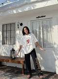 DAXUEN white oversized distressed number 5 graphic tee — model photo
