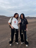 DAXUEN white oversized distressed number 5 graphic tee — model photo