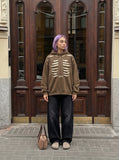DAXUEN Distressed oversized hooded sweatshirt with rib cage graphic