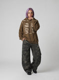 DAXUEN Distressed oversized hooded sweatshirt with rib cage graphic — model photo