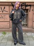 DAXUEN Distressed oversized hooded sweatshirt with rib cage graphic — model photo