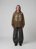 DAXUEN Distressed oversized hooded sweatshirt with rib cage graphic — model photo
