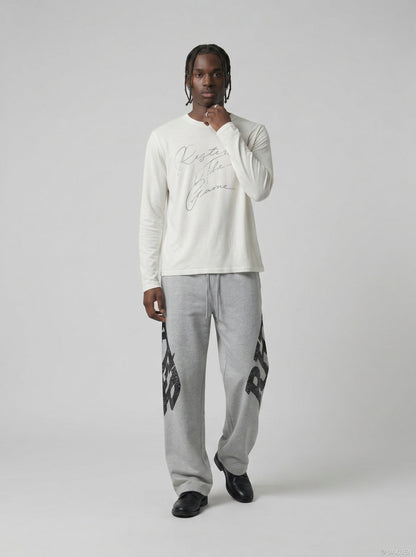 DAXUEN Distressed script long sleeve t-shirt in beige and grey — model photo