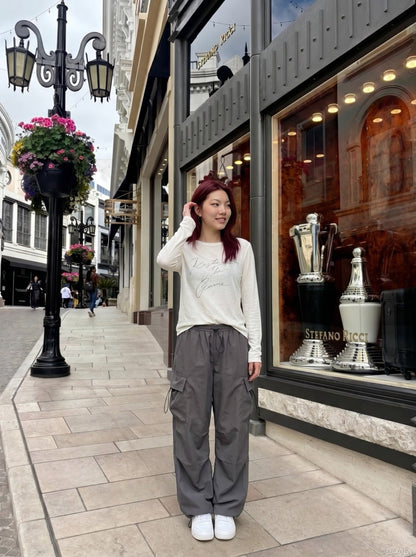DAXUEN Distressed script long sleeve t-shirt in beige and grey — model photo