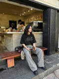 DAXUEN Oversized short-sleeved t-shirt with script print — model photo