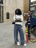 DAXUEN washed dark blue-grey wide-leg sweatpants with sword graphic — model photo