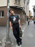 DAXUEN washed black distressed seated-figure graphic t-shirt — model photo